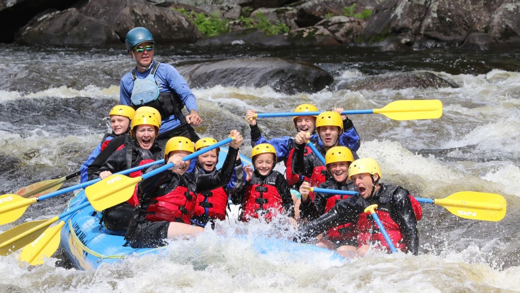 Jamie Haney, General Counsel - North America and Global Specialty Care, (right, second from bottom) navigates white water rapids in a raft with paddles along with nine family members and a guide.